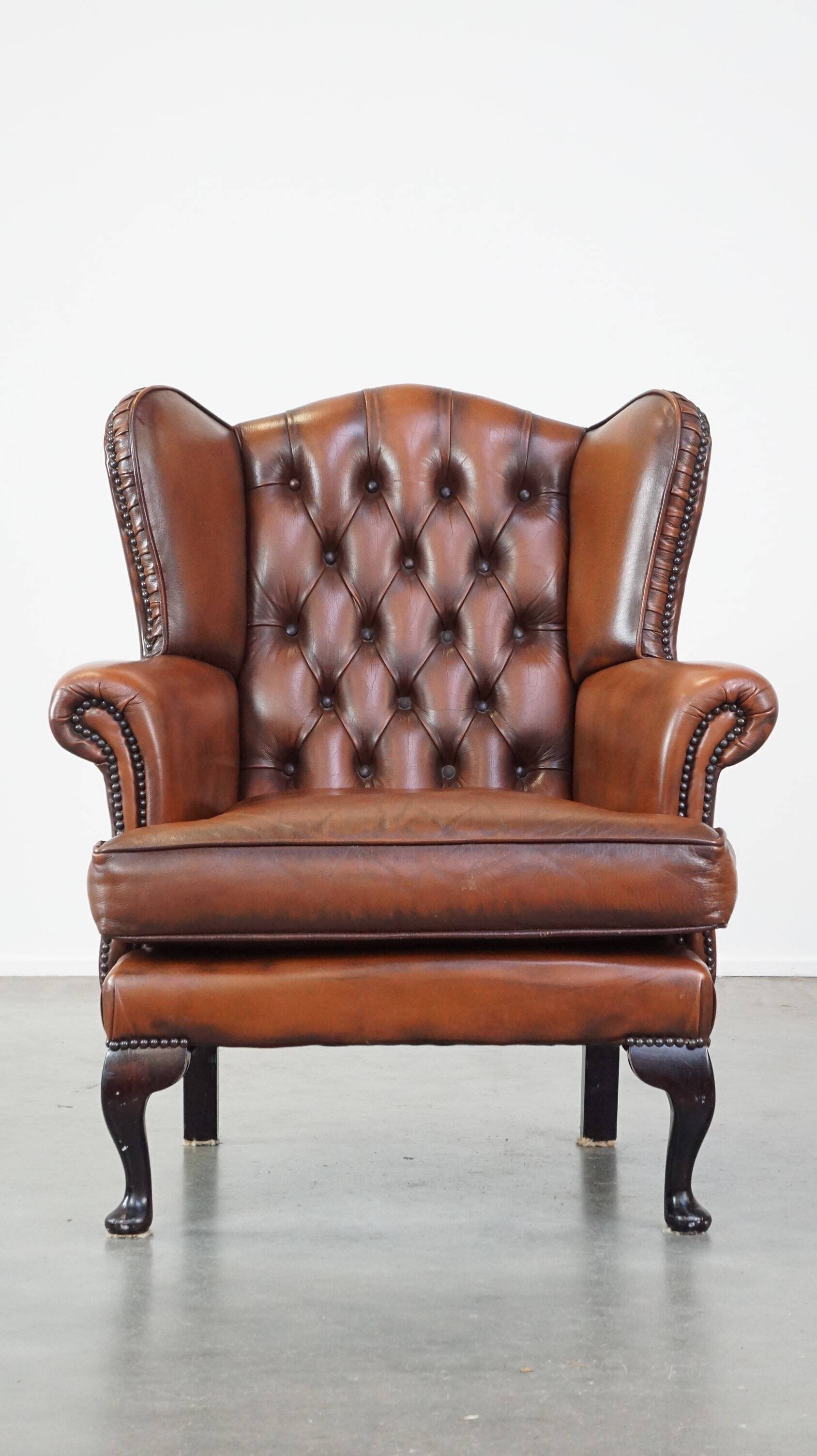 Brown leather wingback Chesterfield armchair