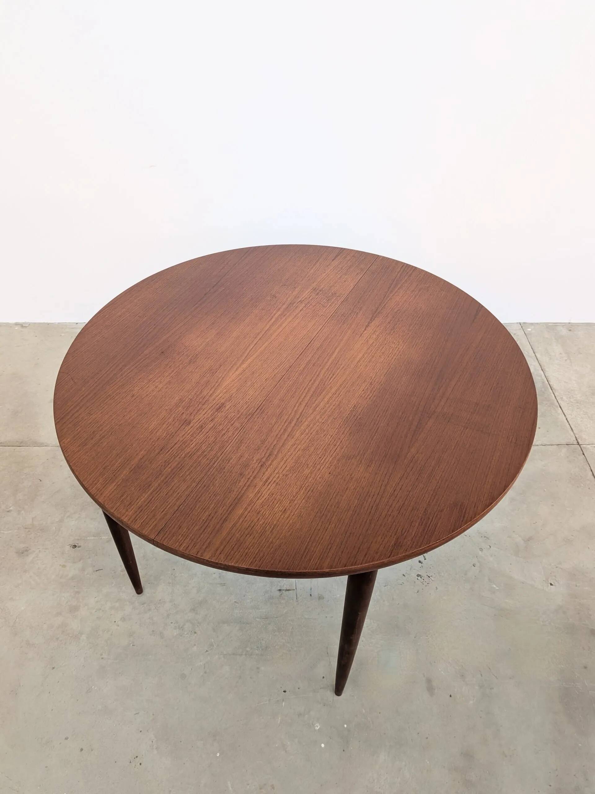 Round extendable wooden dining table