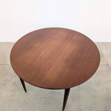 Round extendable wooden dining table