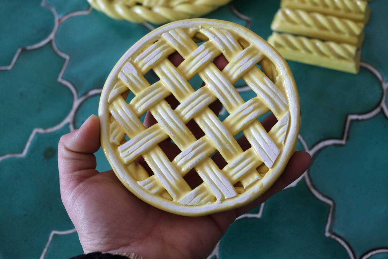 2 yellow ceramic trivets and knife rests
