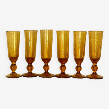 Champagne flutes bubbled amber blown