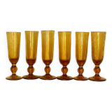 Champagne flutes bubbled amber blown