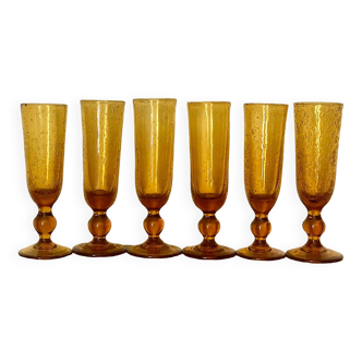Champagne flutes bubbled amber blown