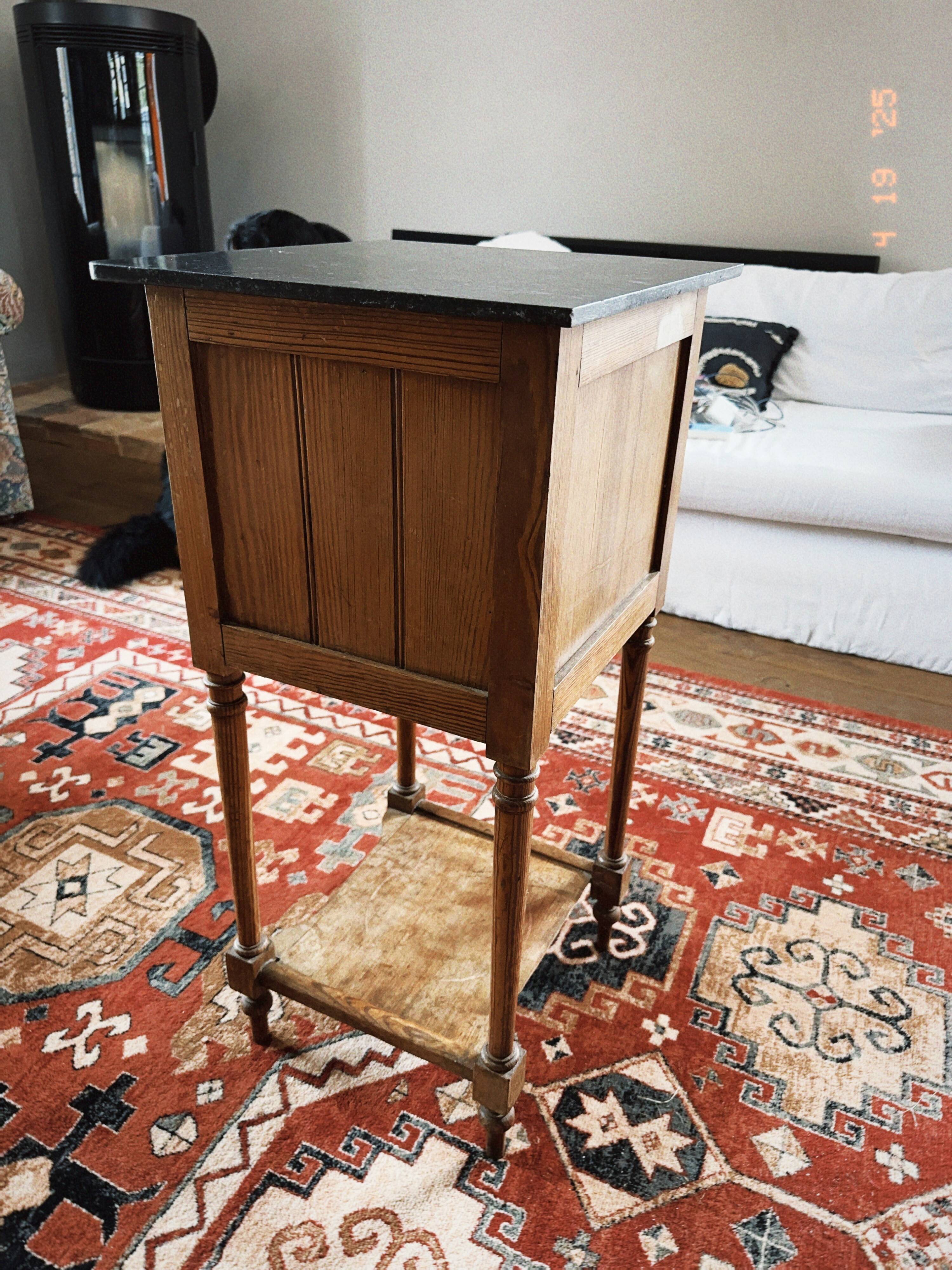 Antique wooden bedside table with marble top