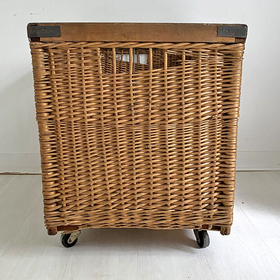 Old large wicker laundry basket on wheels