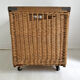 Old large wicker laundry basket on wheels
