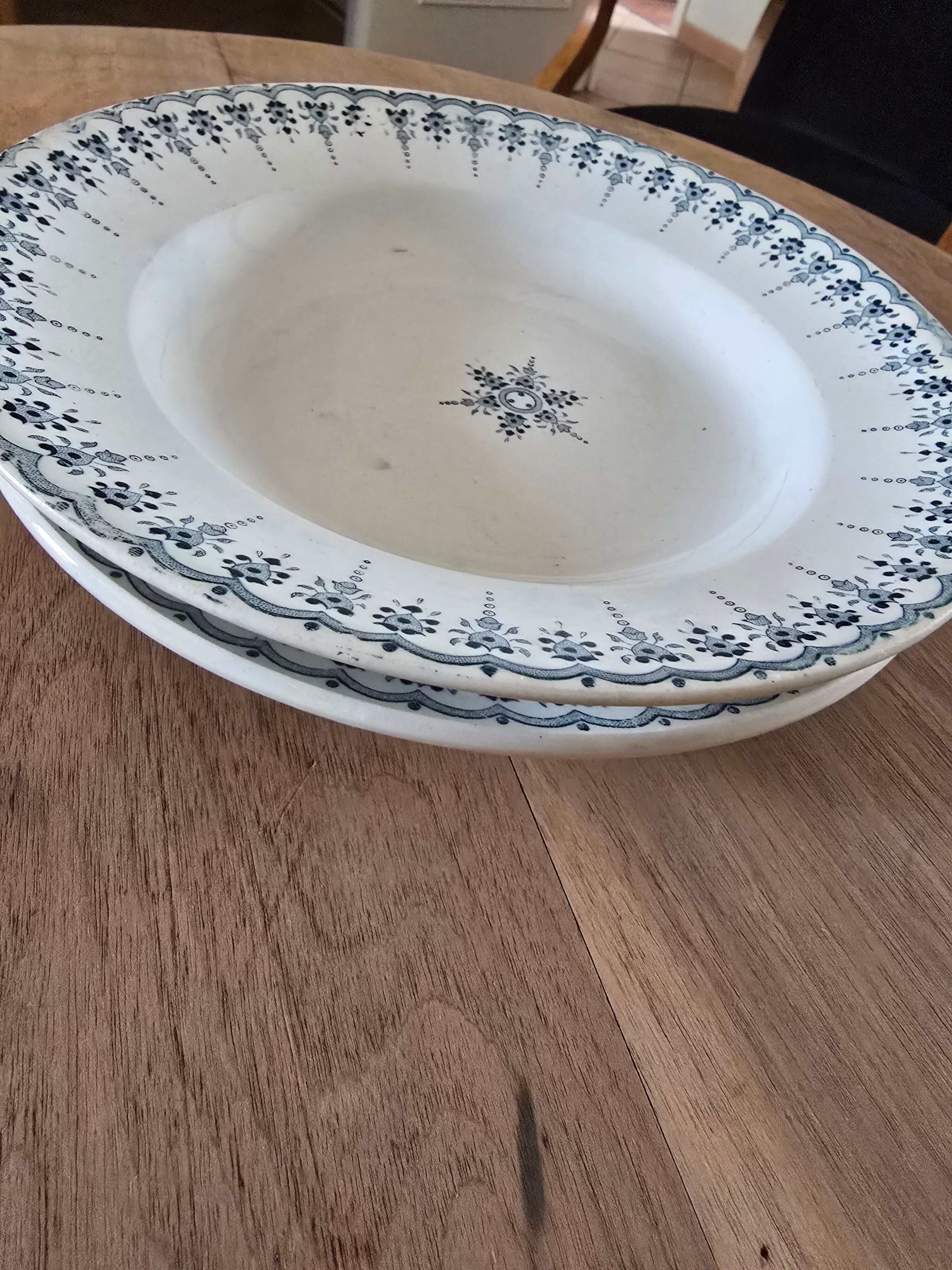 Old green-blue faience plates and dishes with geometric patterns.