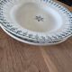 Old green-blue faience plates and dishes with geometric patterns.