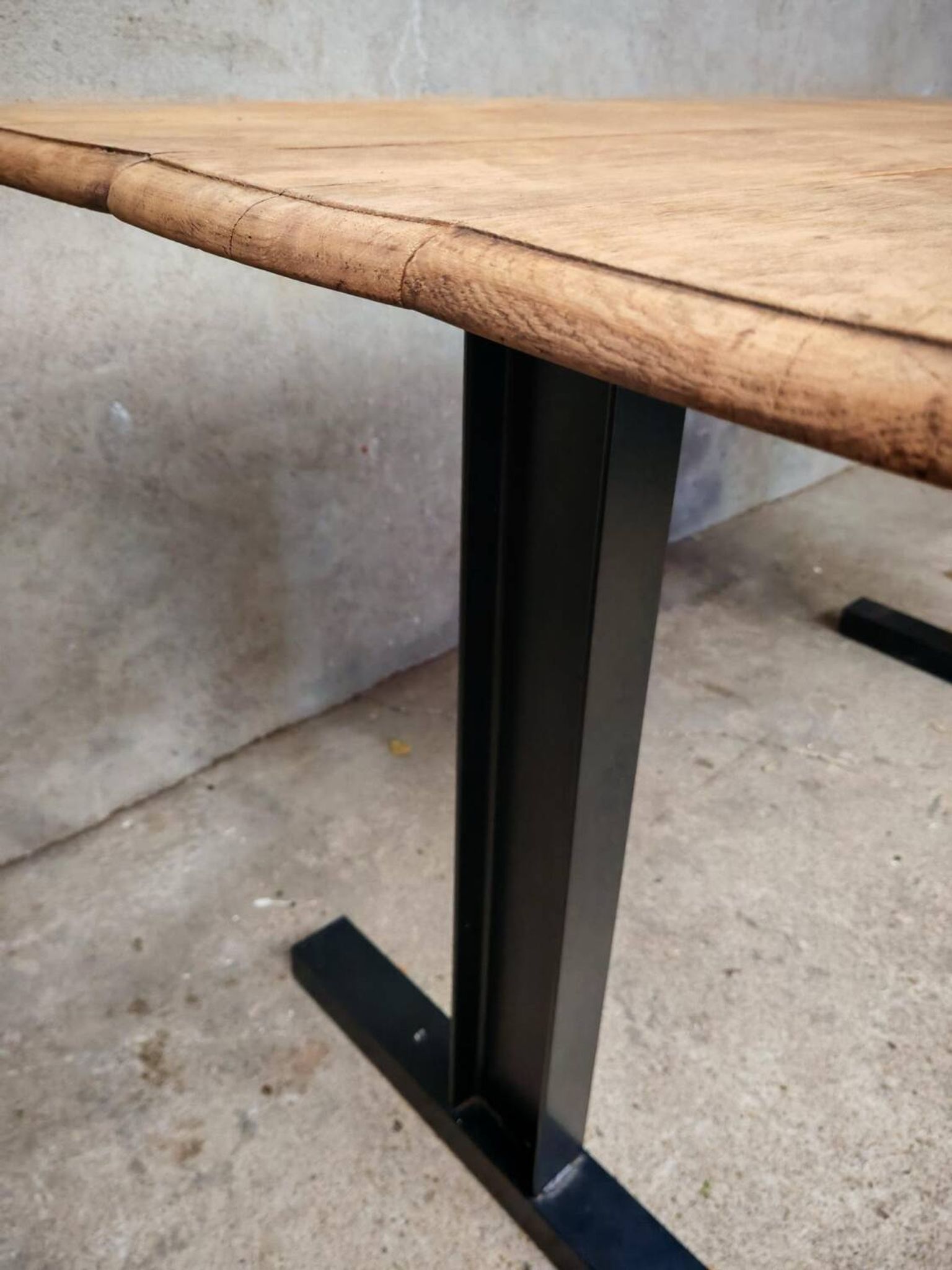 Unique wooden table with metal industrial legs.