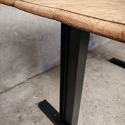 Unique wooden table with metal industrial legs.