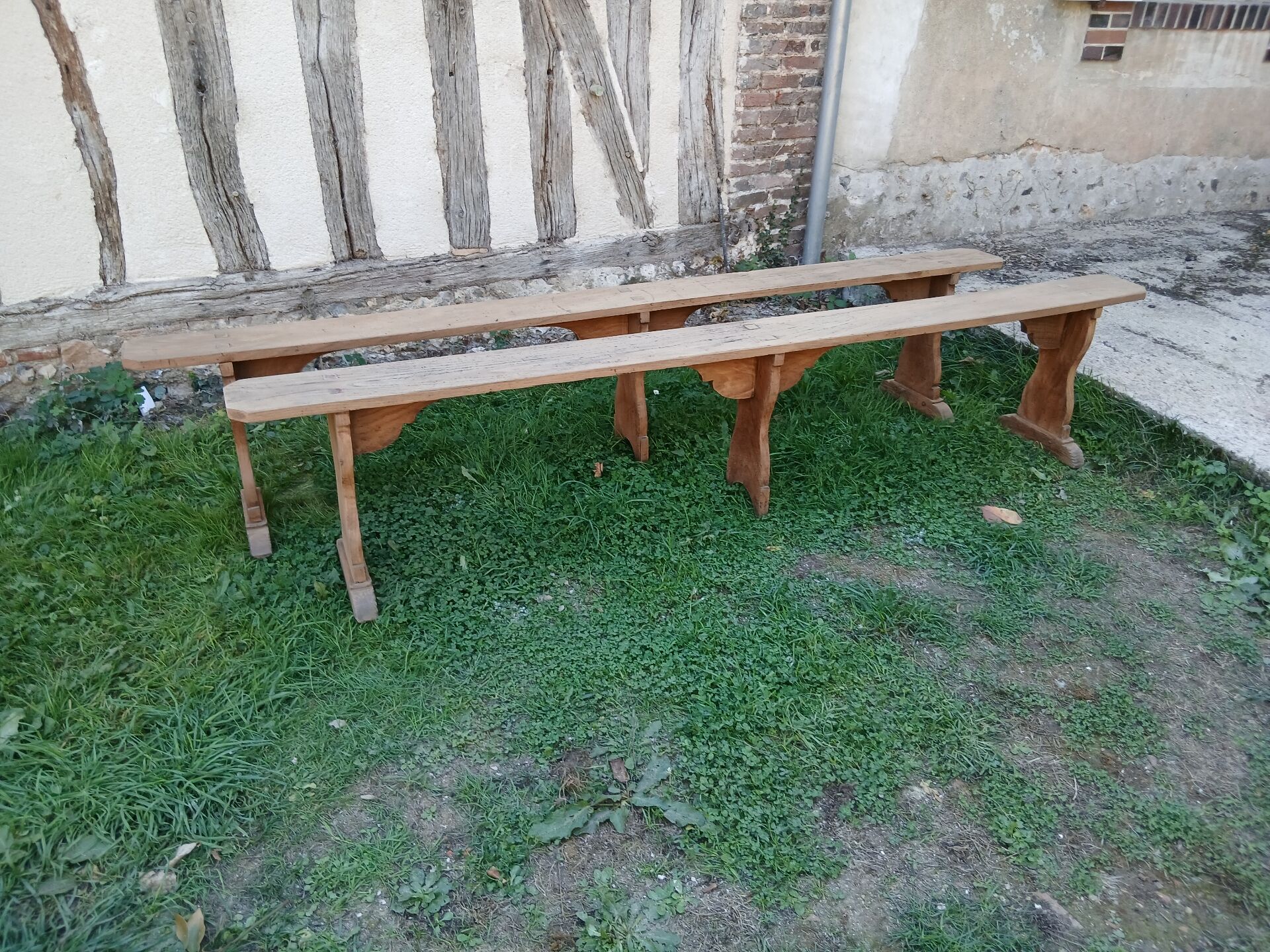 Pairs of large benches in raw fir wood.