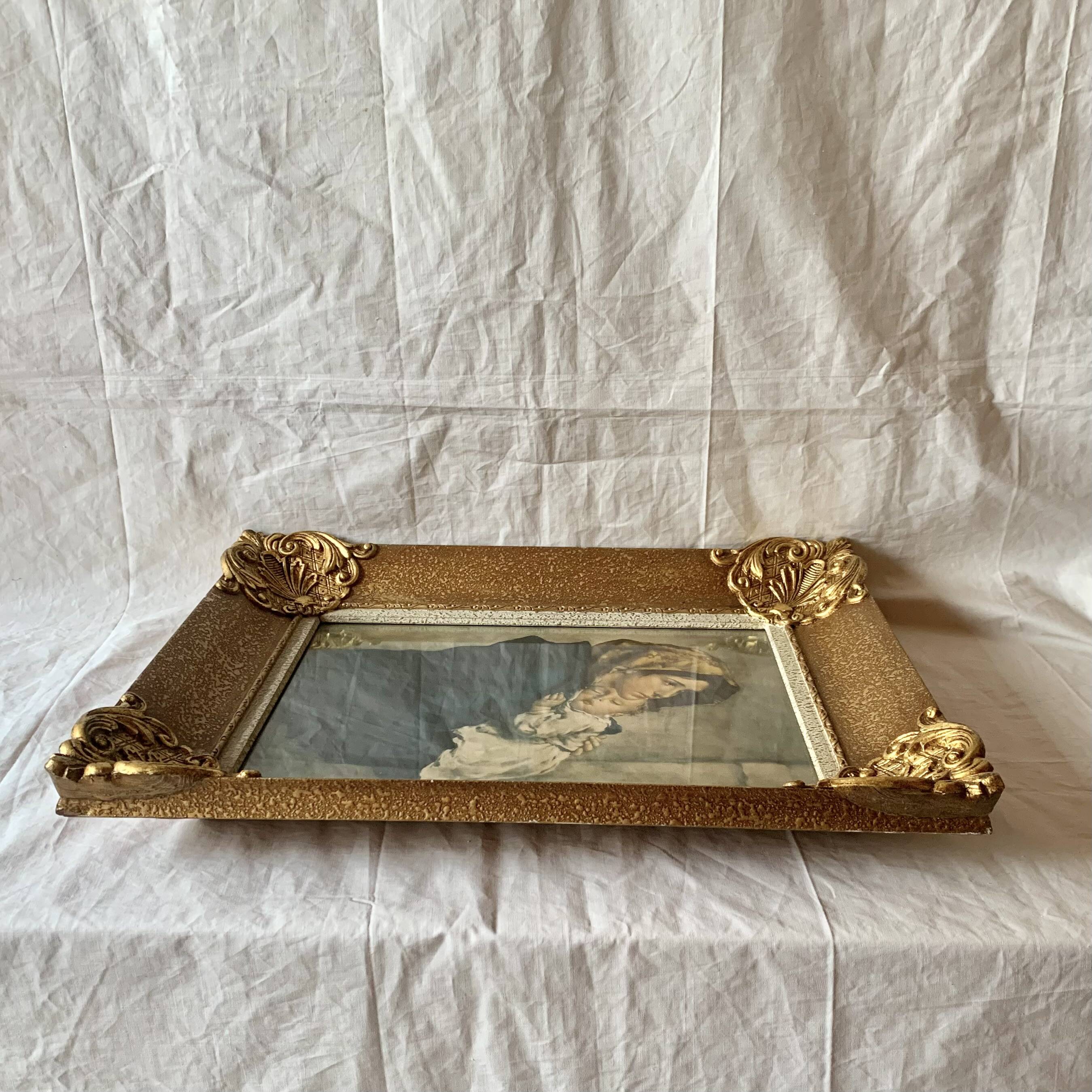 Old wall frame in carved gilded wood