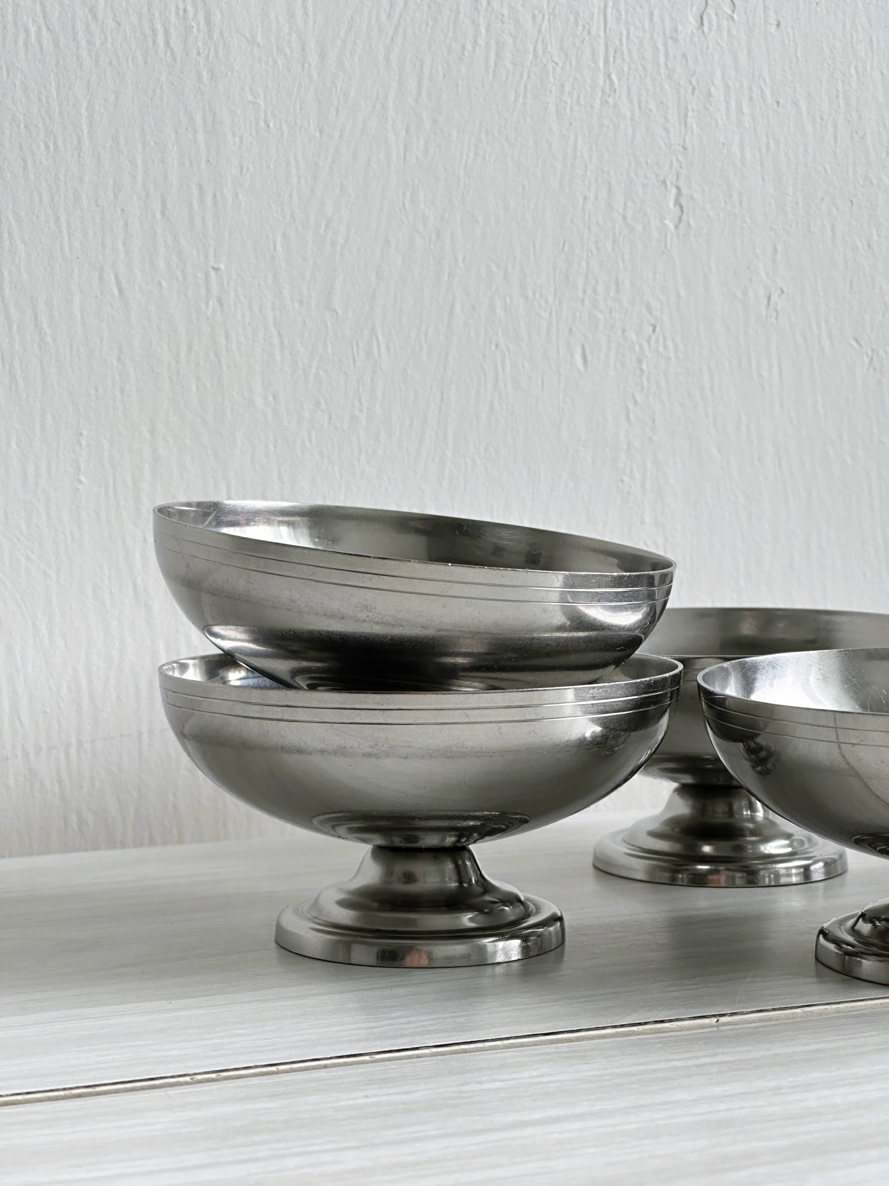 5 silver metal cups.