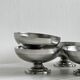 5 silver metal cups.