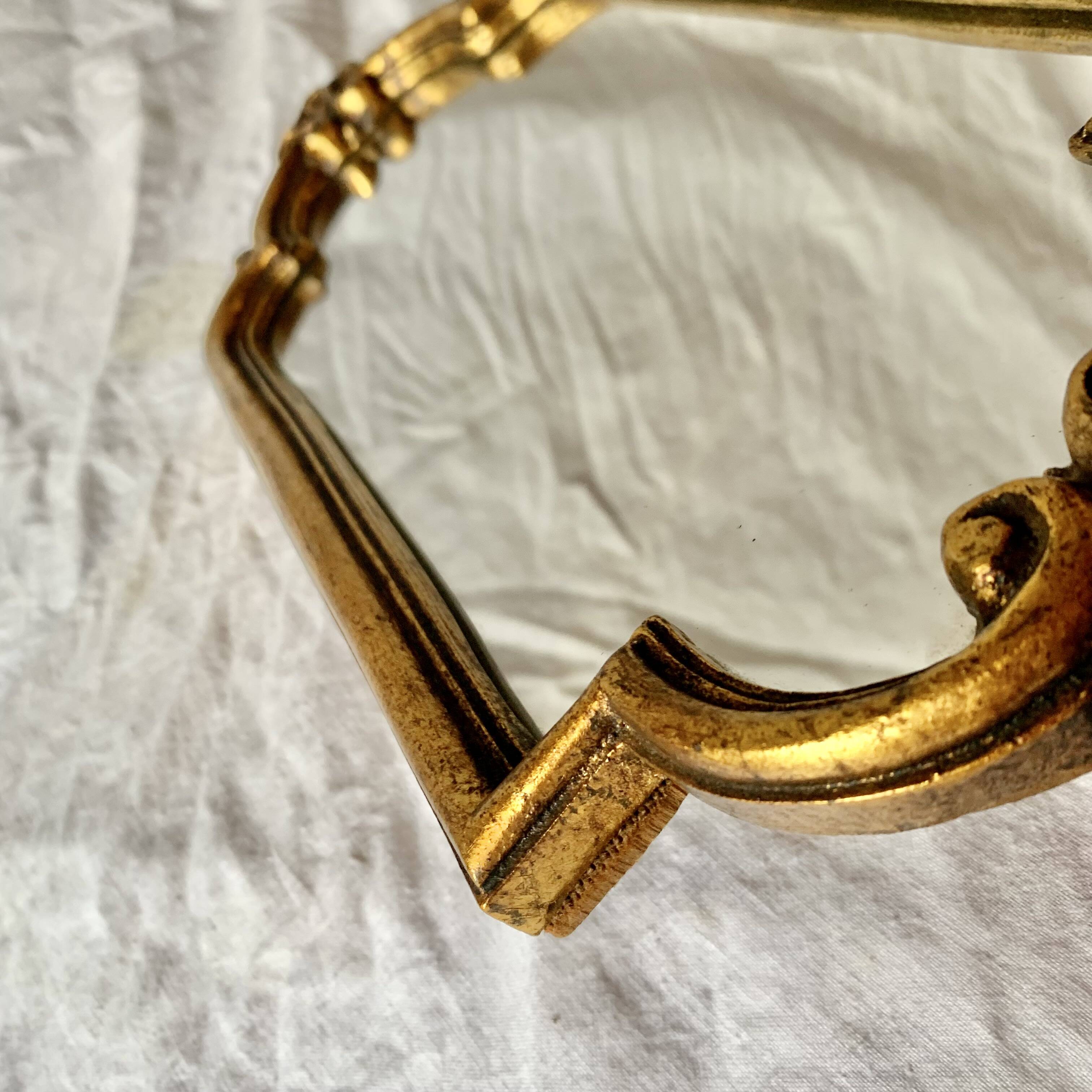 Old small wall mirror in golden resin