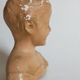 Bust of a small child in ancient plaster