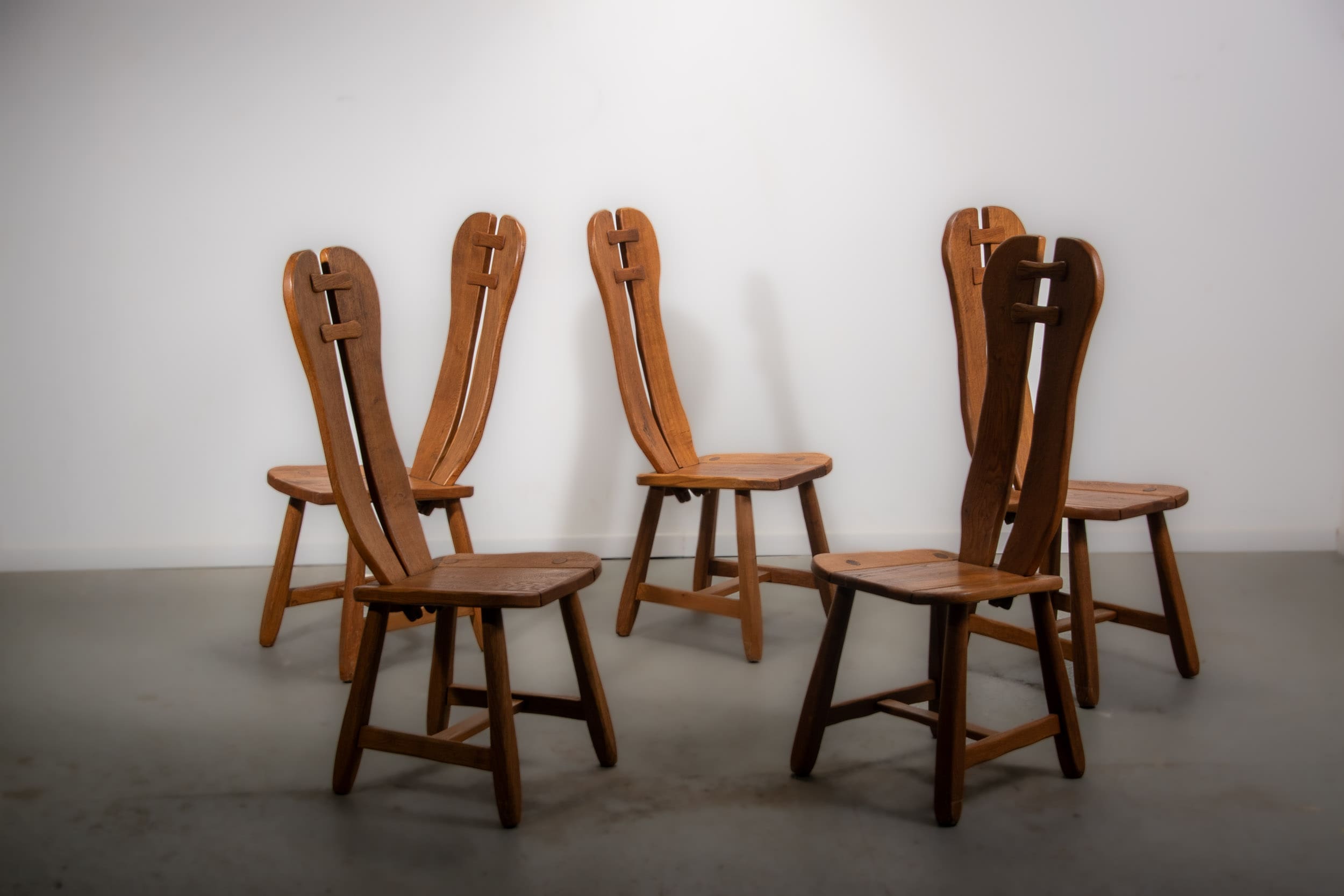 De Puydt brutalist dining chairs in solid oak. Circa 1970.