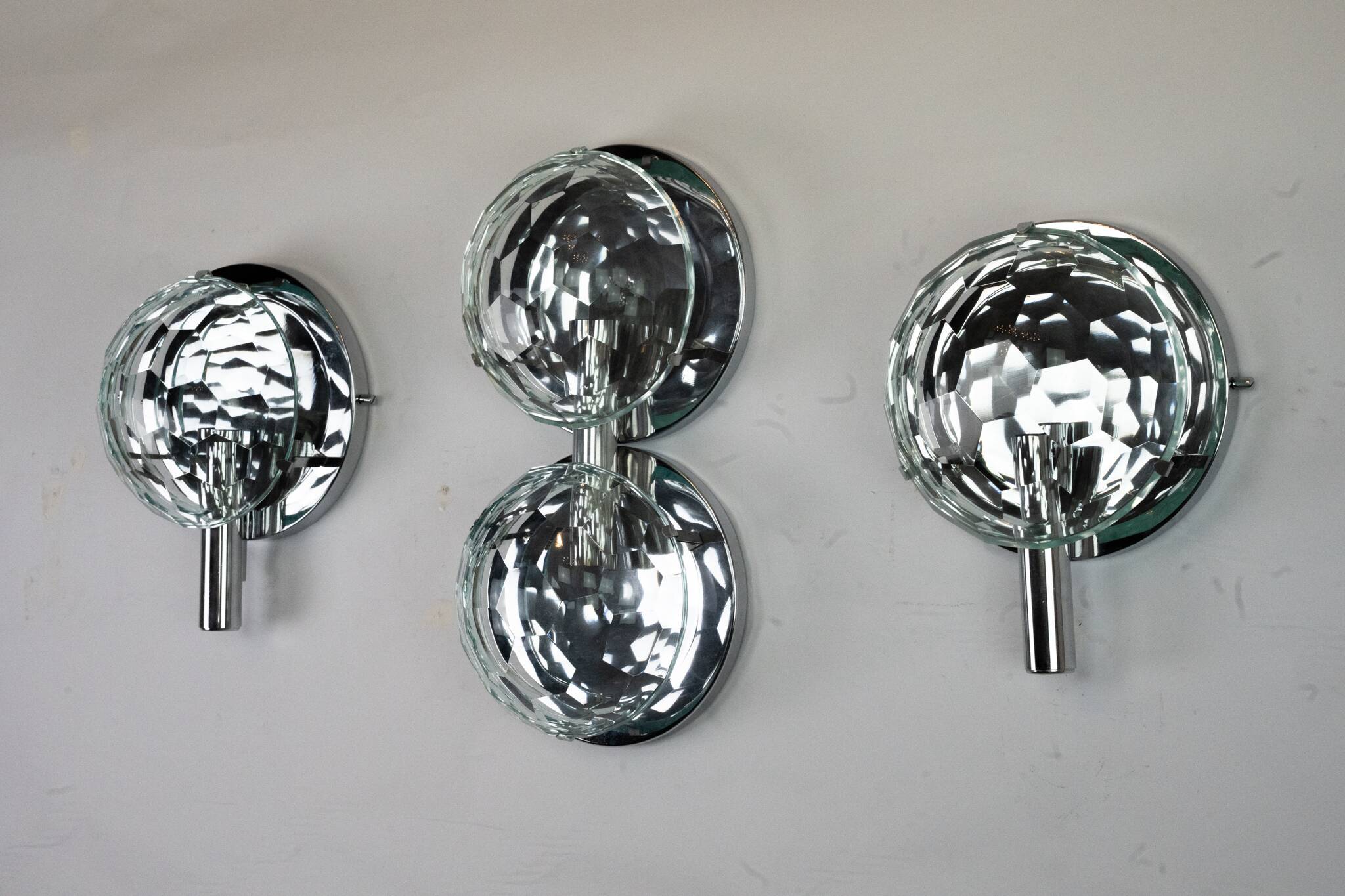 Set of three Cristal Art sconces in chrome and cut glass. Italy 1970s