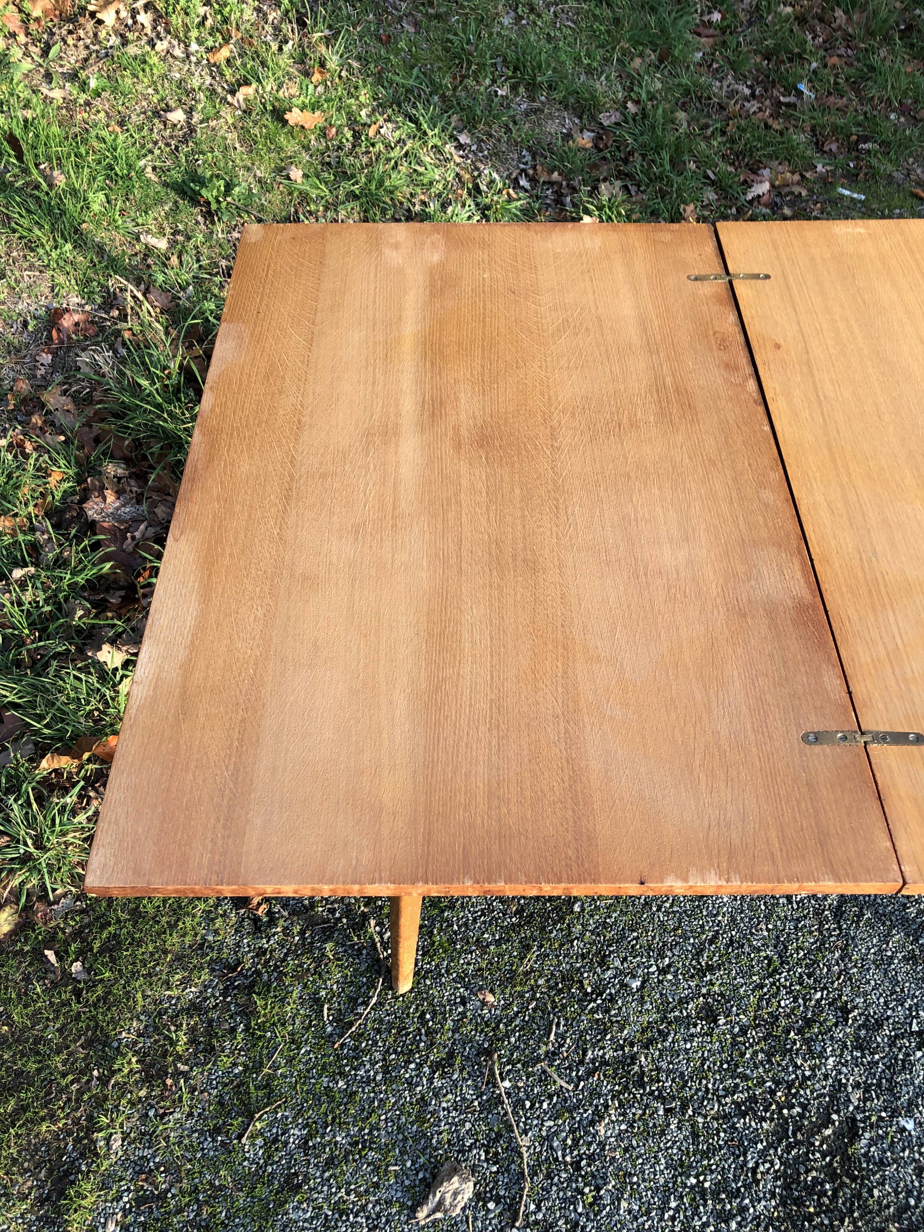 Vintage so-called portfolio table with oak compass base and its oak cp swivel top.