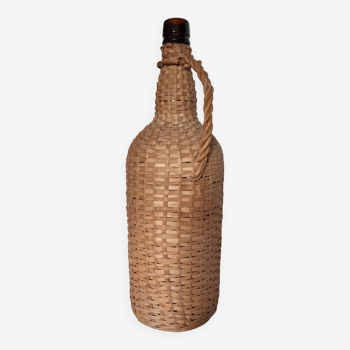 Old high wicker glass bottle