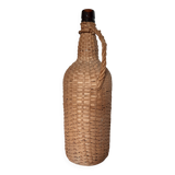 Old high wicker glass bottle