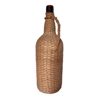 Old high wicker glass bottle