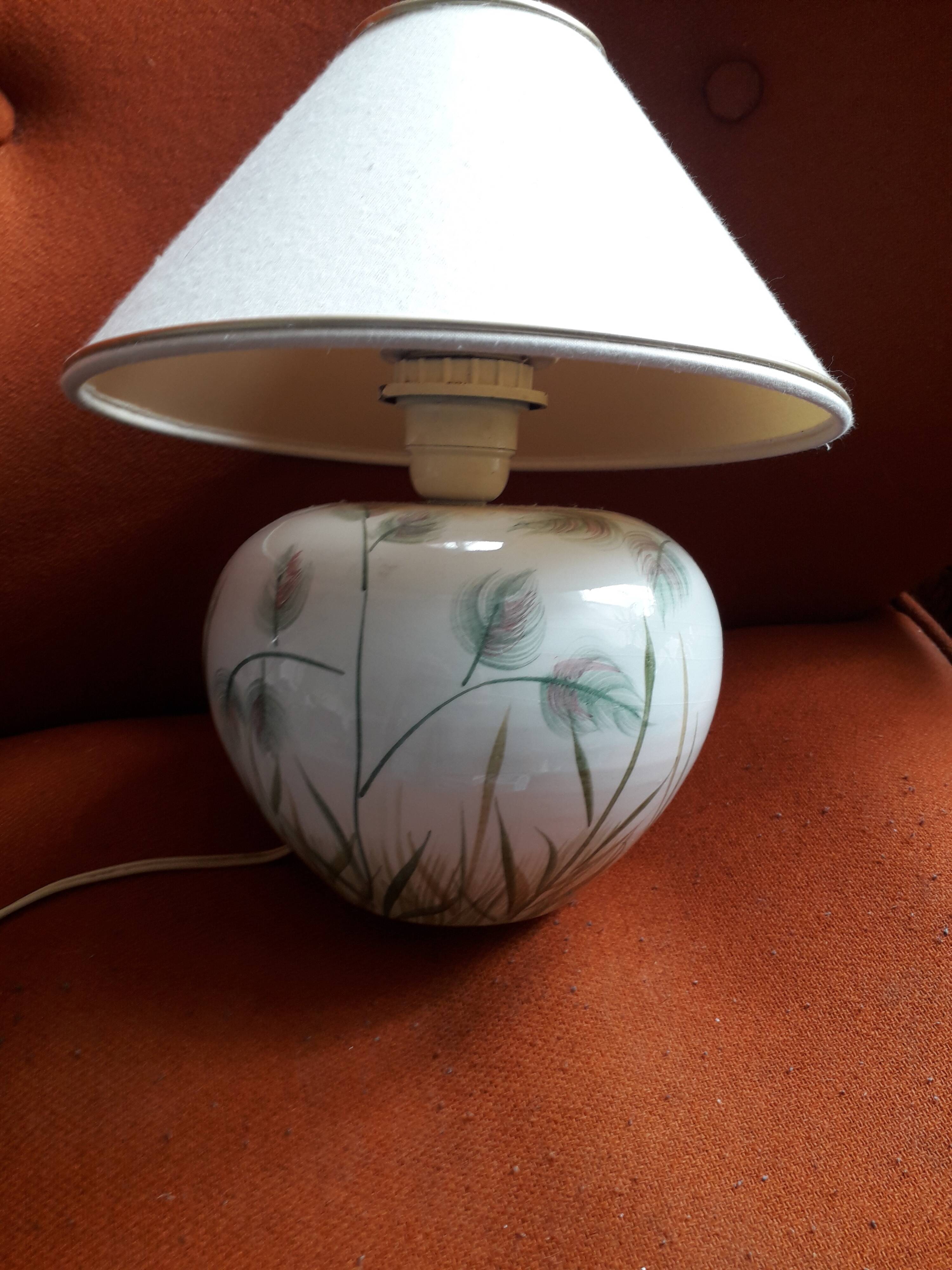 Antique ceramic lamp with a floral design.