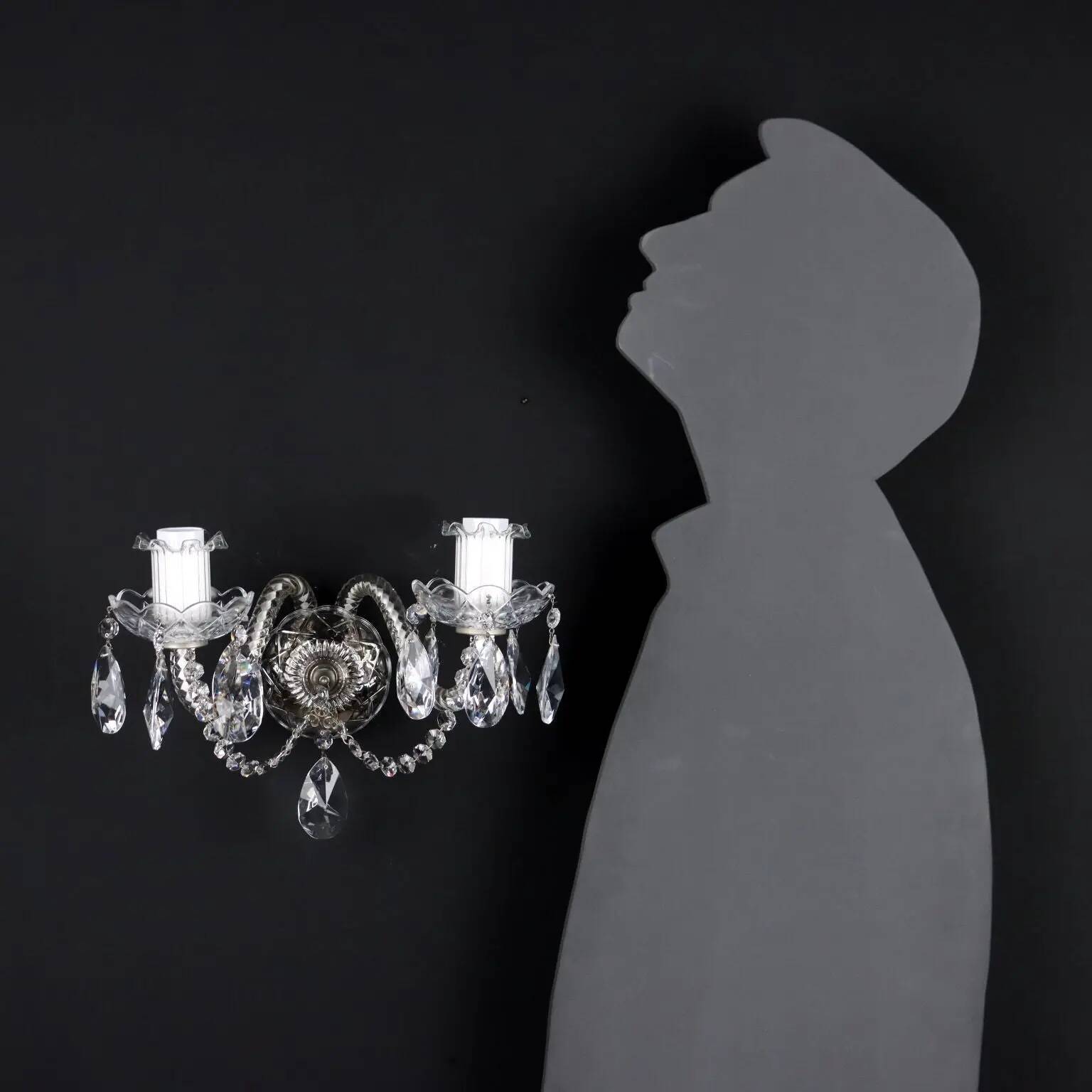 Antique wall light with 2 lights from the 1900s, featuring crystal bobeches and pendants.
