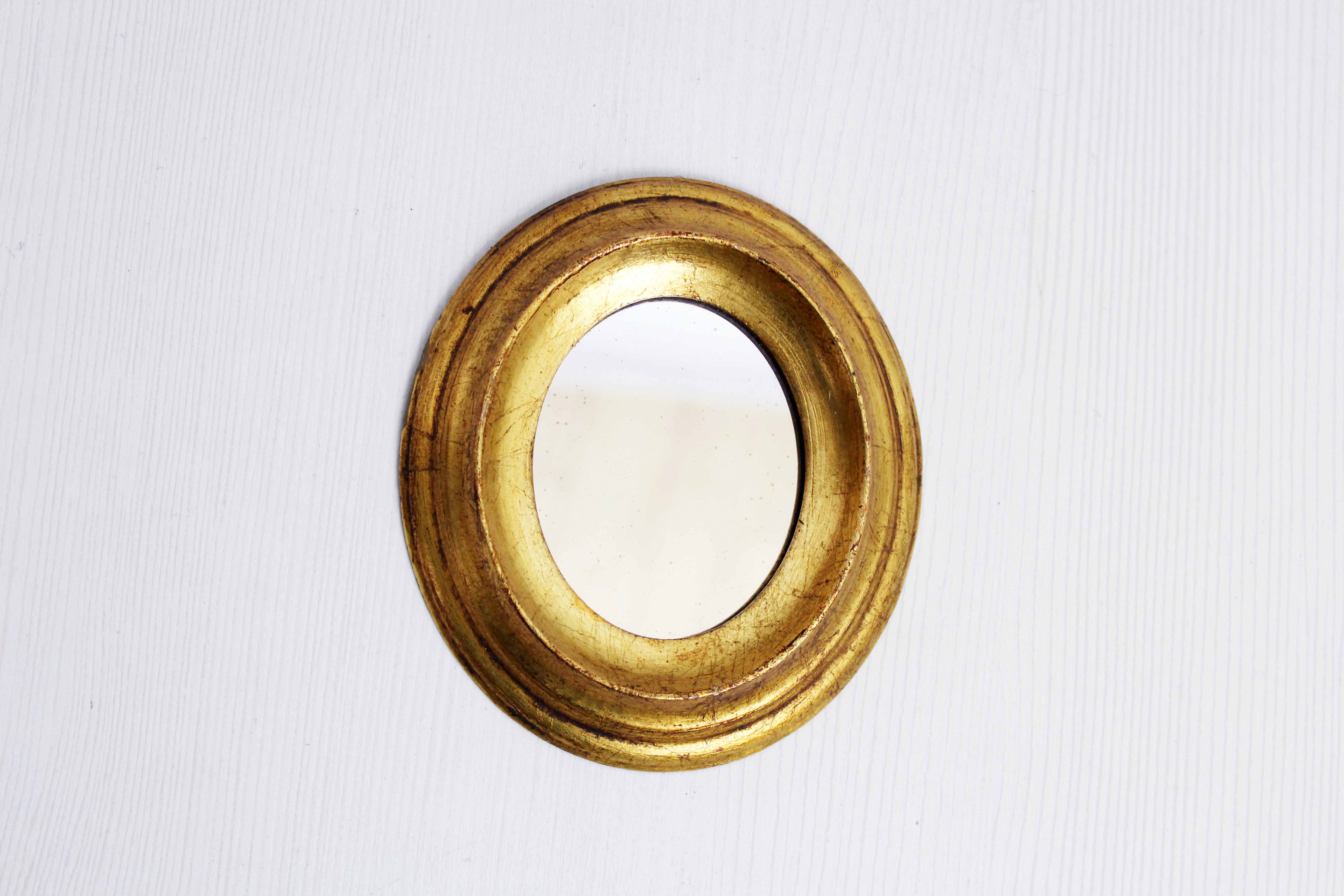 Golden oval mirror