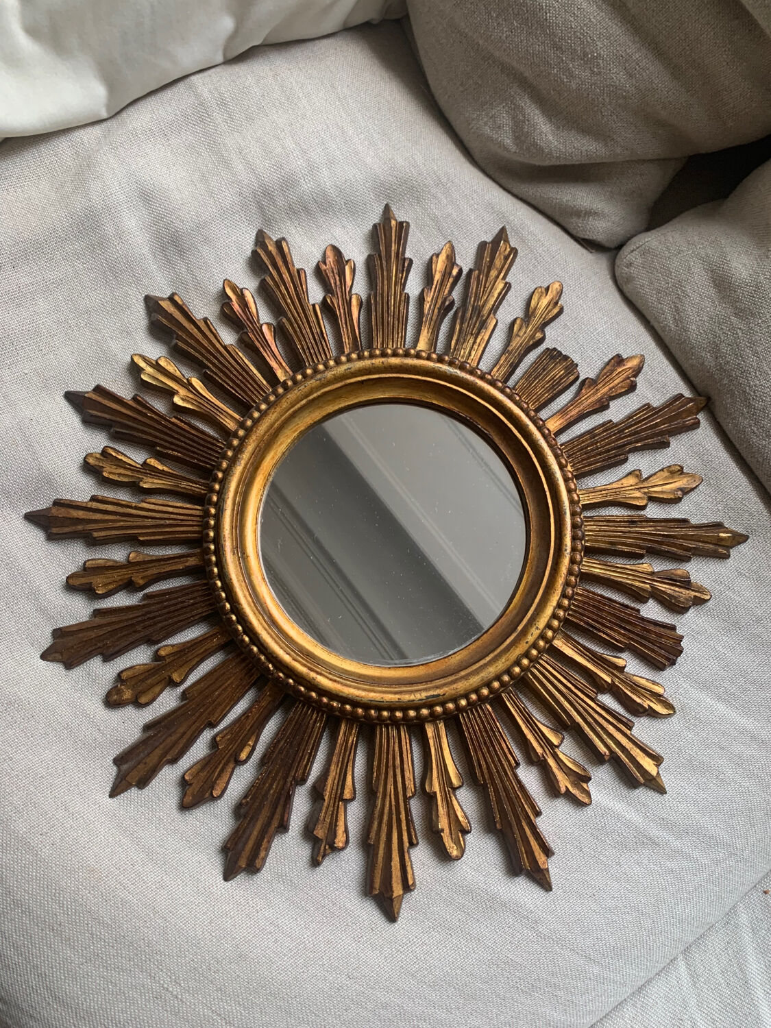 Sun mirror in old wood