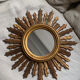 Sun mirror in old wood