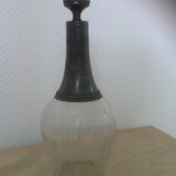Old carafe with peddling cap