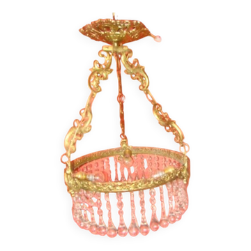 circular chandelier with a brass frame fitted with crystal drops