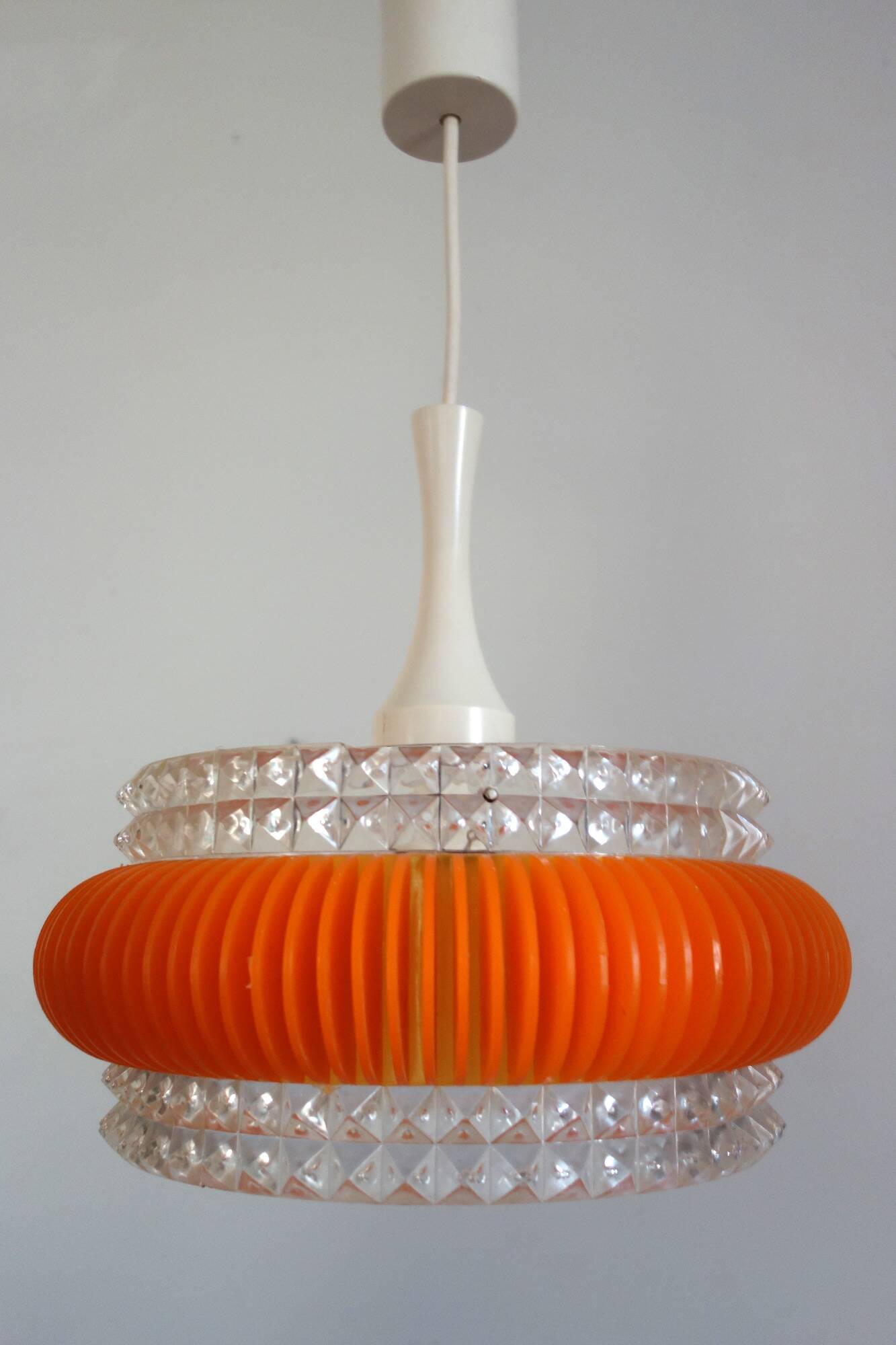 Transparent plastic space age lustre with orange band from the 70s.