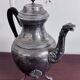 Empire style silver-plated verseuse, resting on three sculpted feet.
