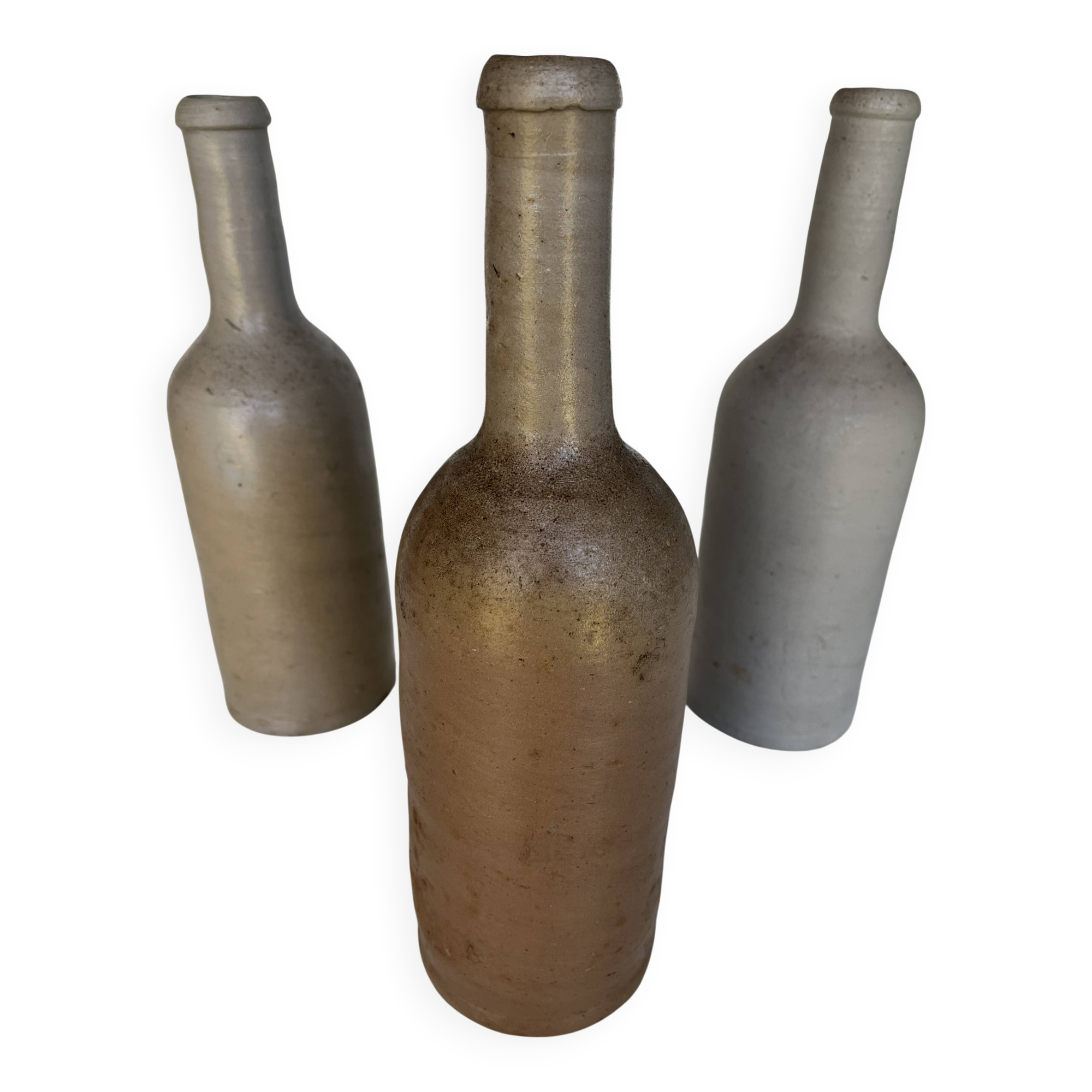 Trio of antique matte stoneware bottles