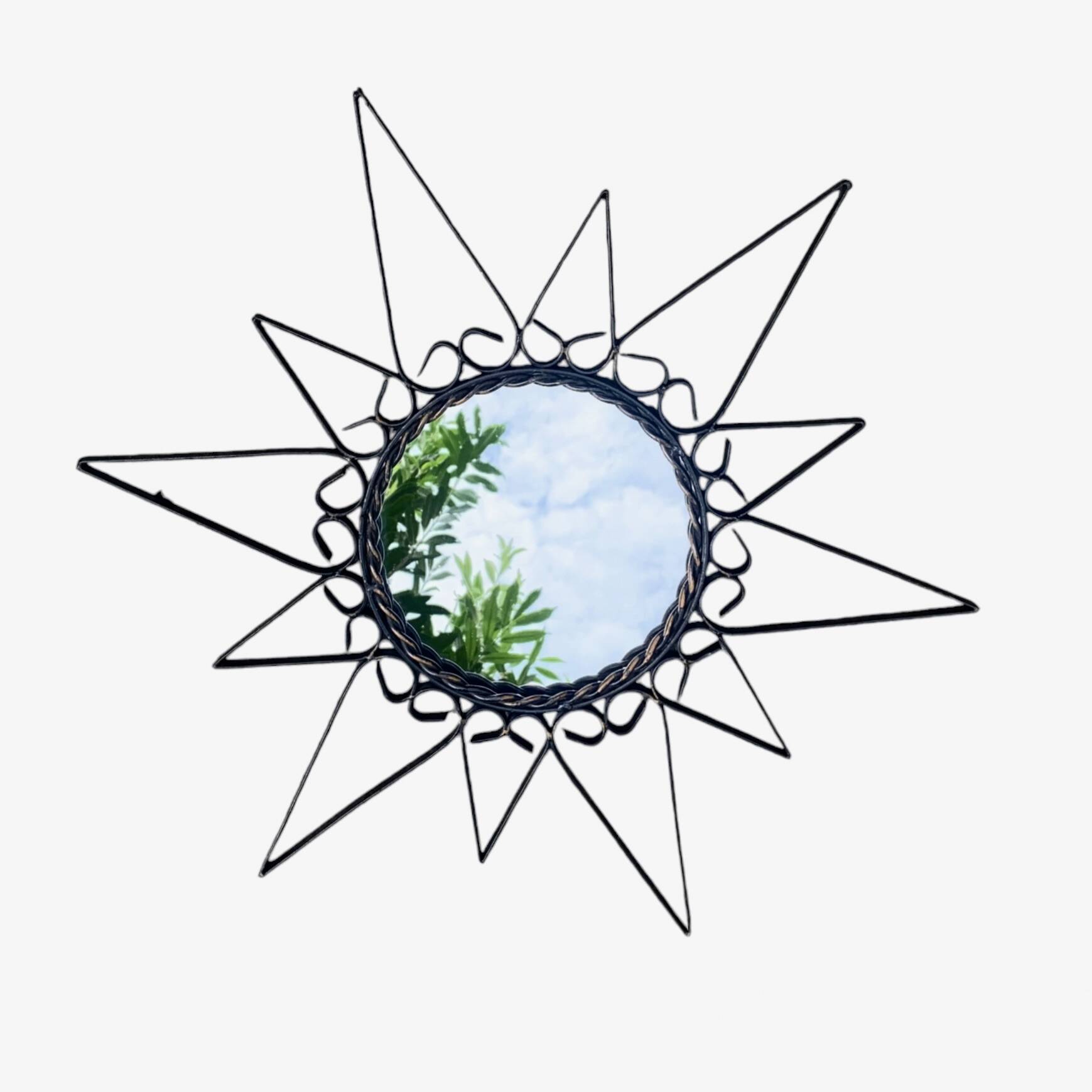 Old wrought metal sun mirror