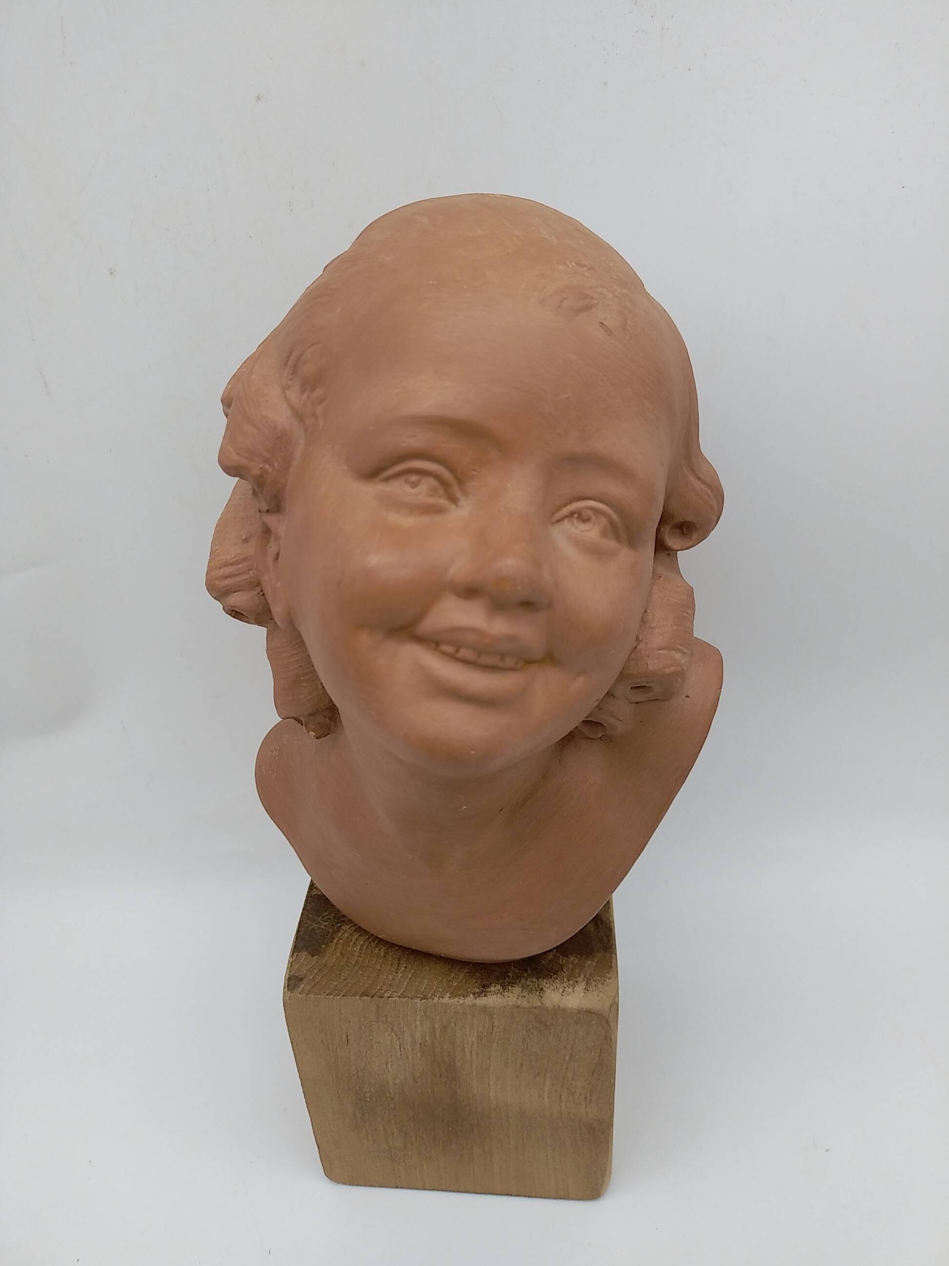 Bust young smiling girl. Circa 1900. Art Deco. Signed.