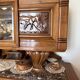 Solid wood sideboard with marble top and carved panels.