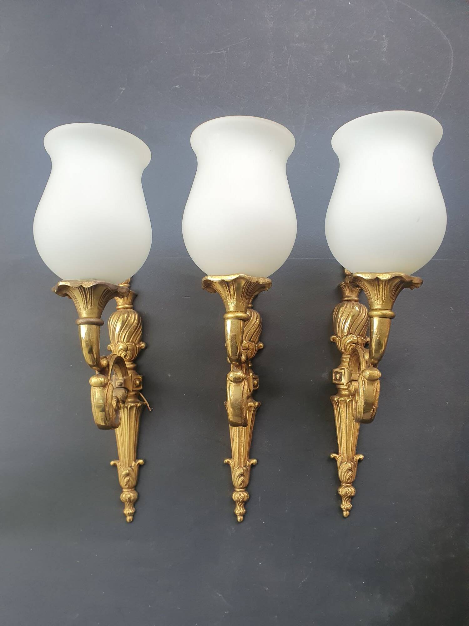Three large vintage torch wall sconces.