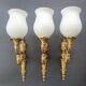 Three large vintage torch wall sconces.