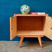 Rockabilly design bedside table with tapered legs.