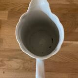Old ceramic pitcher decorated with flowers