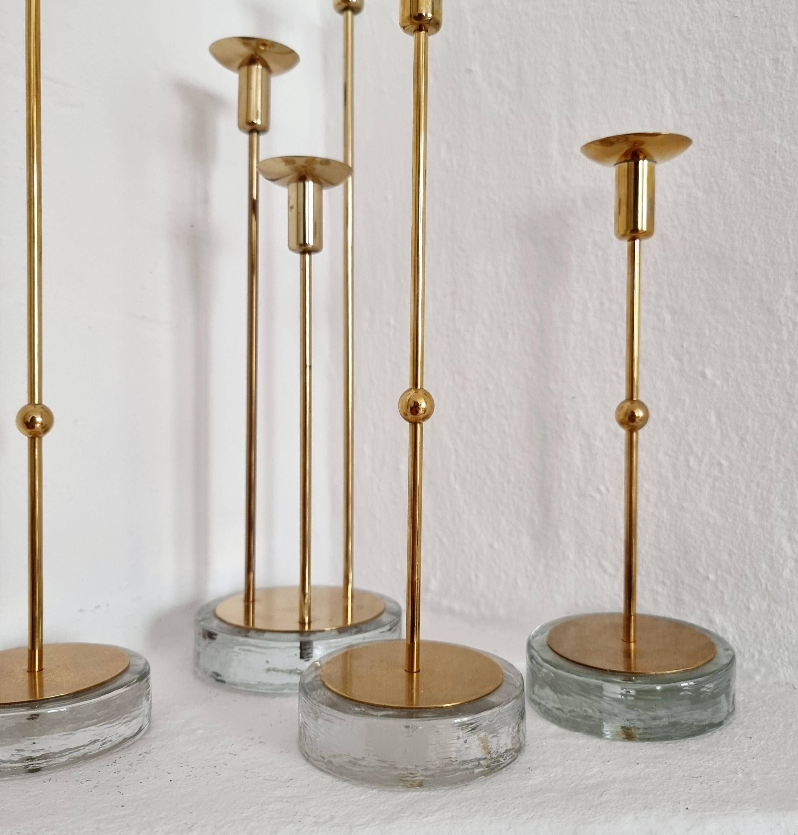 Gunnar Ander, four candlesticks, brass and glass, Ystad Metall, Swedish modern.