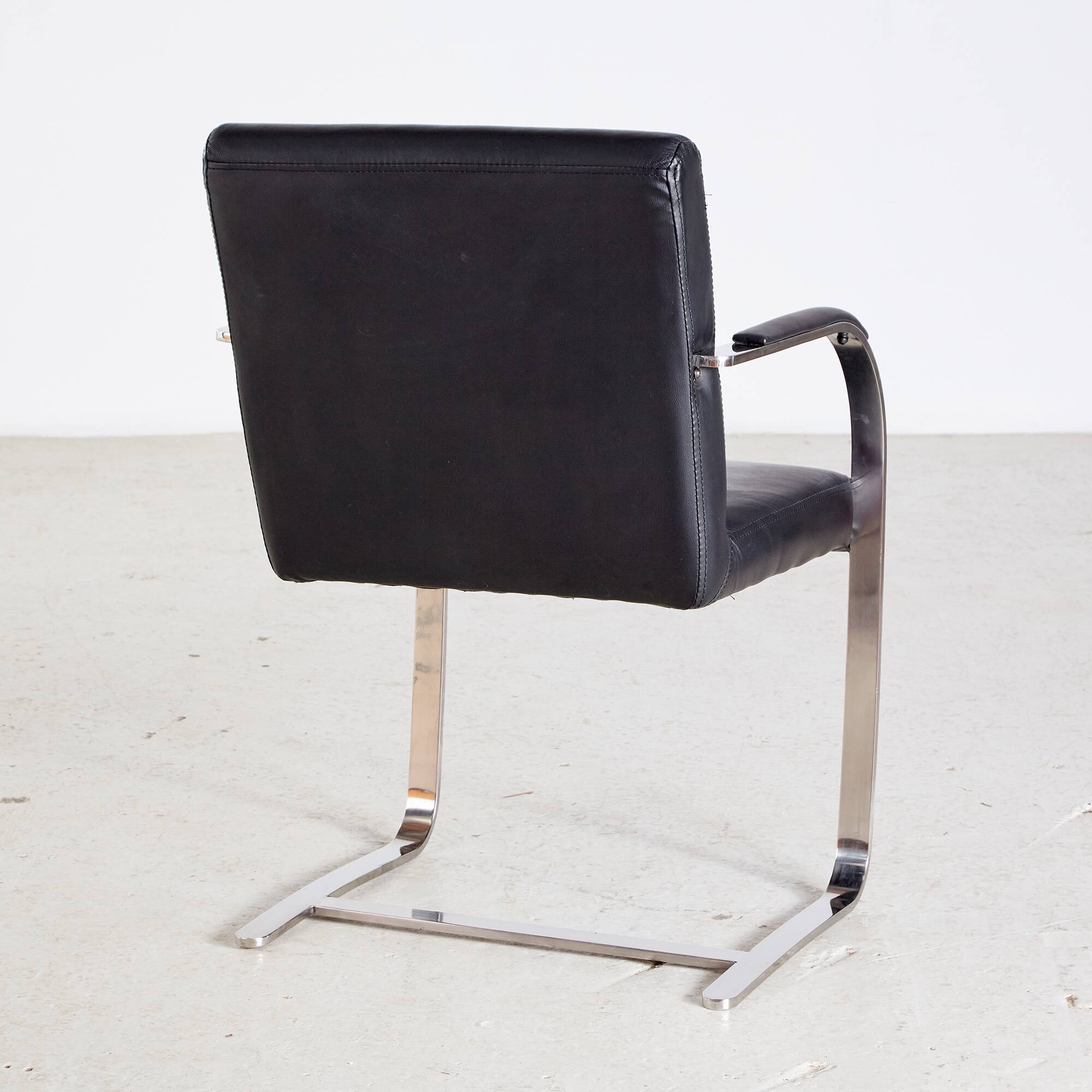 Steel armchair with leather upholstery