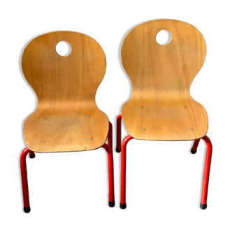 Pair of wooden and red metal child chairs