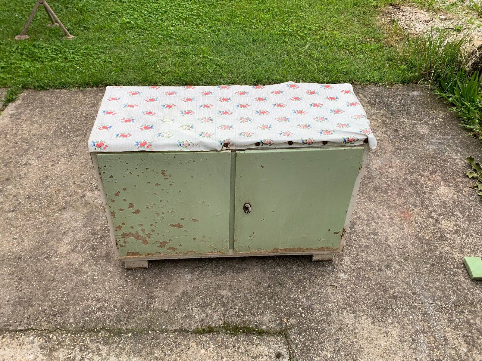 Vintage low wooden cabinet painted green and white with a floral fabric top (1950s)