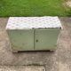 Vintage low wooden cabinet painted green and white with a floral fabric top (1950s)