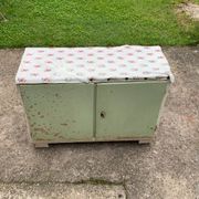 Vintage low wooden cabinet painted green and white with a floral fabric top (1950s)