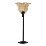 Table lamp with a lampshade with magnificent golden reflections